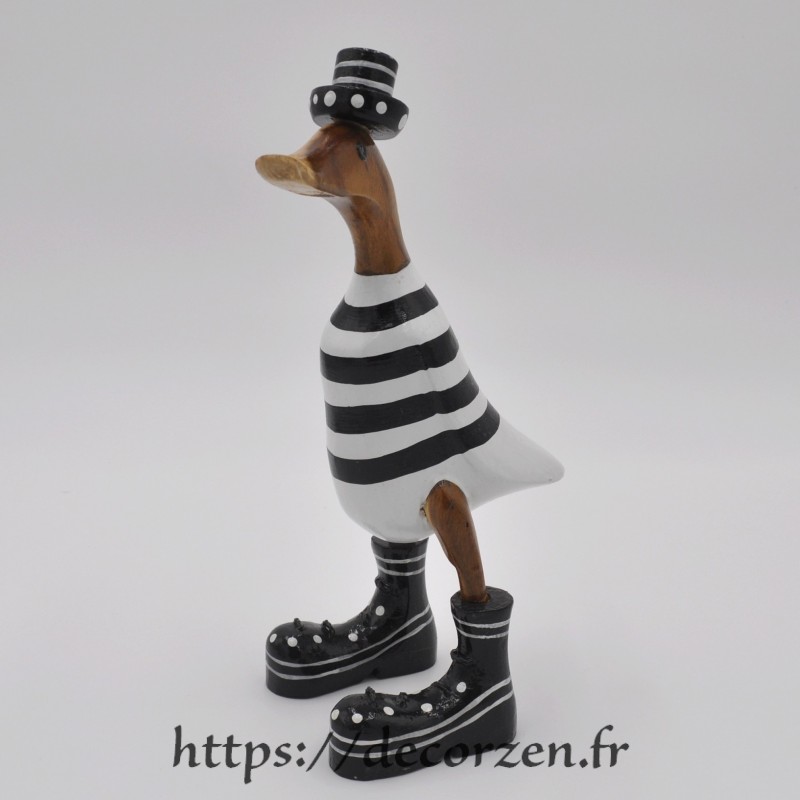 Un grand et superbe canard en marinière blanche et noire, en teck et bambou