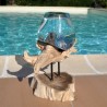 Verre recyclé soufflé en fusion sur du bois flotté.