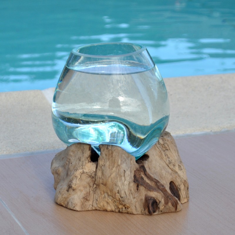 Un vase en verre recyclé soufflé à la bouche en fusion sur du bois flotté